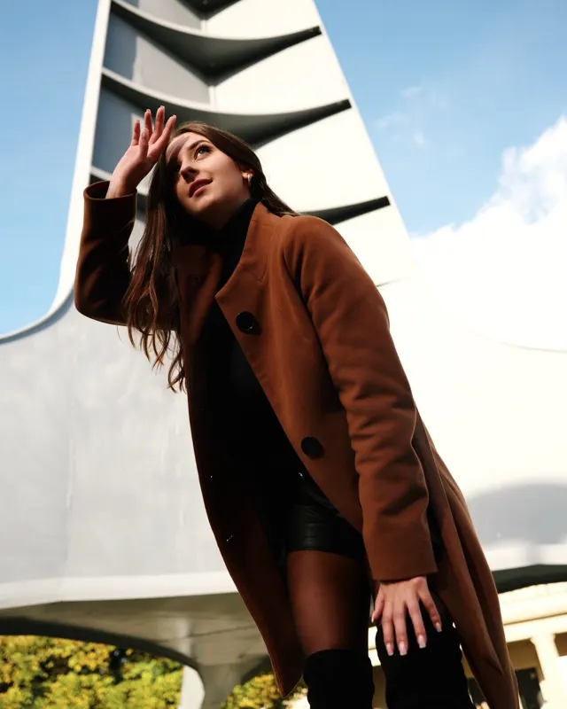 Natalia in brown coat against modern architecture, portrait session Wrocław