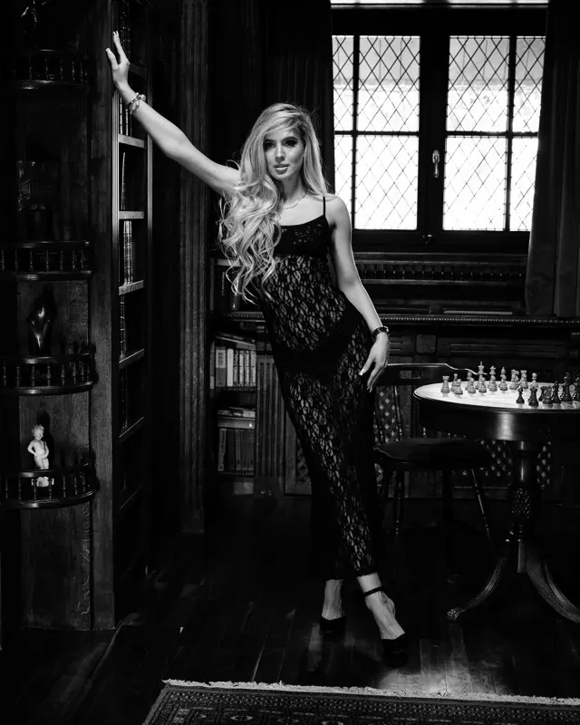 Monika in lace jumpsuit in elegant study room, black and white photoshoot Warsaw