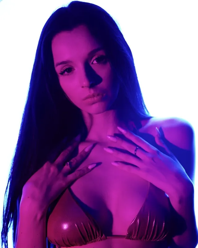 Nikola in neon purple-blue lighting, atmospheric fashion session in Wrocław